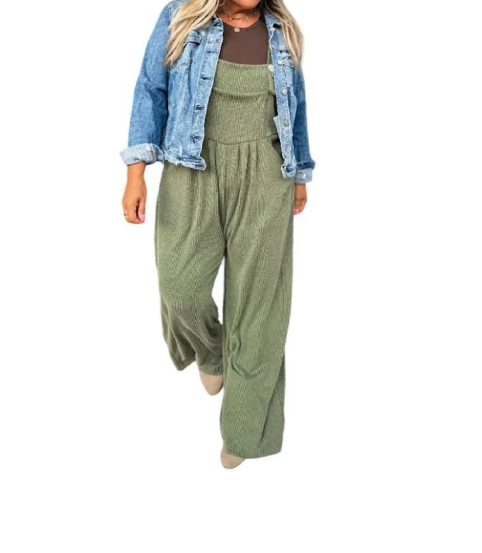 Jeans with a faux leather patch at the back pocketKarli Boho Overalls In Olive